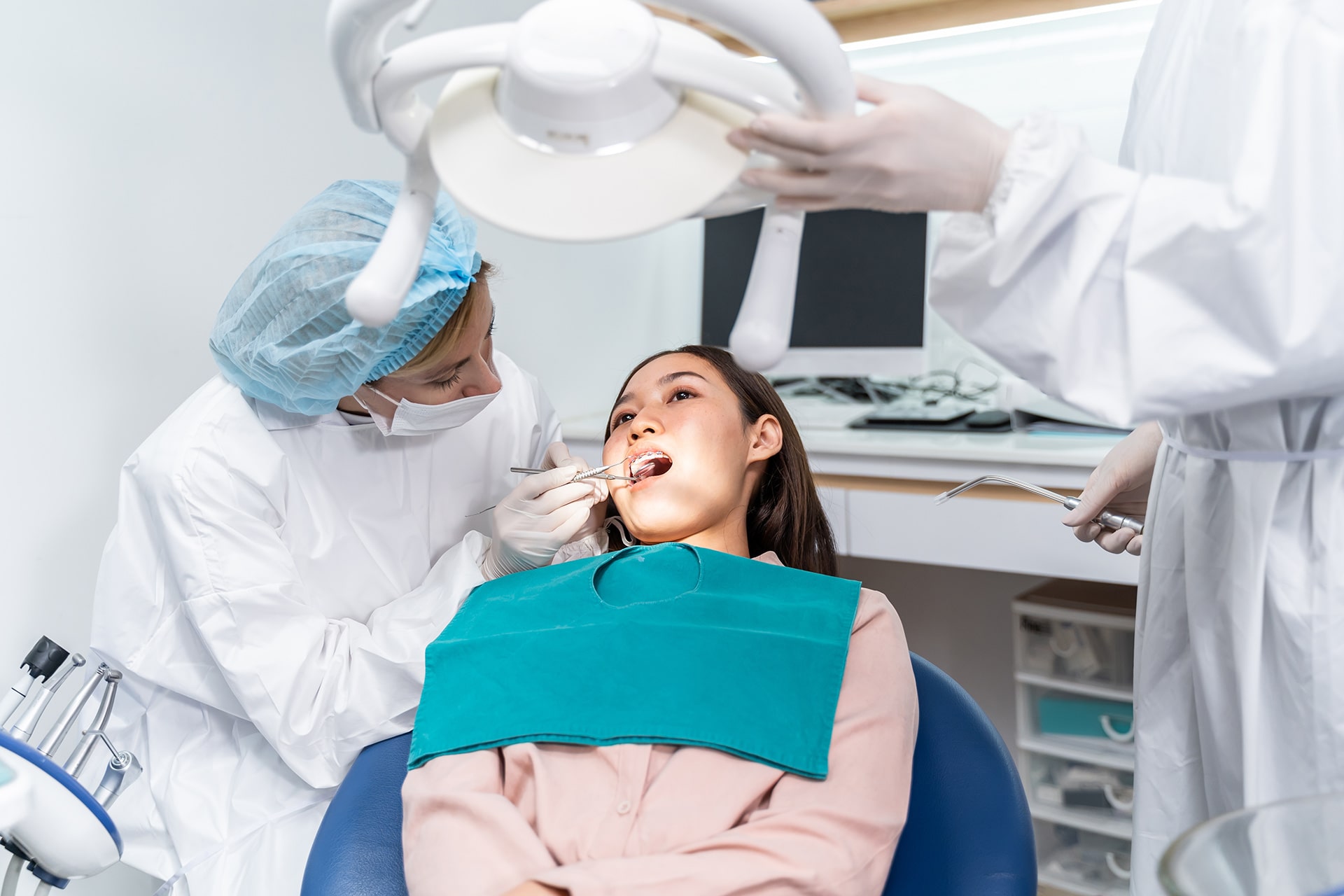 Dentist examining a patient's teeth during dental implant treatment in Adelaide
